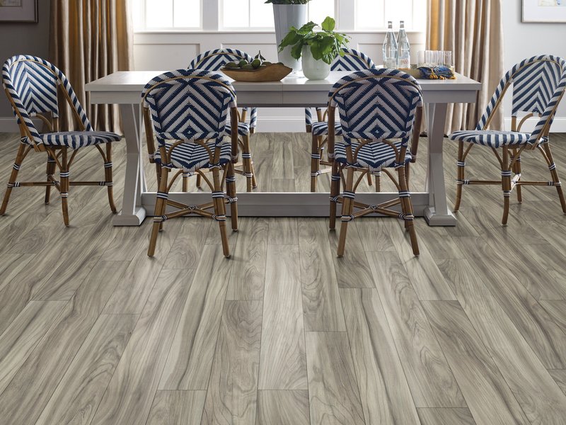 Dining room with blue and white chairs and wood-look repel laminate flooring from Triangle Flooring Center in Carrboro, North Carolina