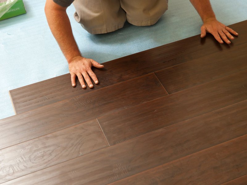 Person installing hardwood flooring from Triangle Flooring Center in Carrboro, North Carolina